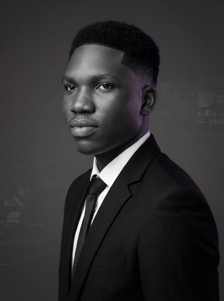 Professional black and white portrait of a man in a suit with soft cinematic lighting, representing a creative and tech-focused brand identity.
